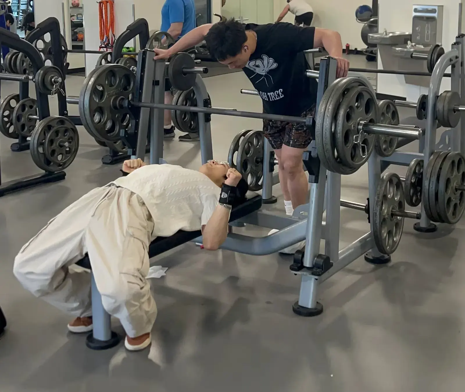 Liam at the gym on a bench press with a training partner.